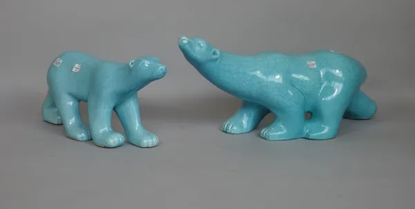 A pair of earthenware polar bears by L & V Ceram, second half 20th century, each covered in a blue crackled glaze, printed mark, largest 49.5cm. lengt
