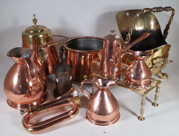 A large quantity of mostly early 20th century brass and copper wares, including jugs, urns, fire buckets and sundry, (qty).