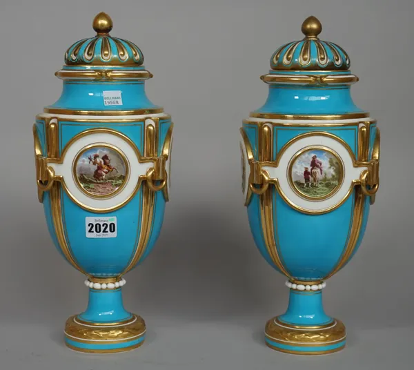 A pair of Minton turquoise ground urns and covers, circa 1860-69, printed factory mark, urn form with four roundels, each raised and with falconry sce