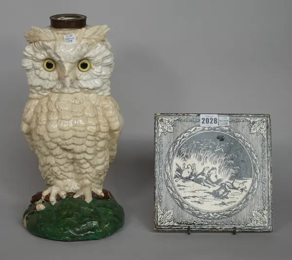 A Minton Hollins and Co Arts and Crafts pottery tile, black printed, with a frog group, 20cm x 20cm, and an 'owl' form pottery oil lamp base, 36cm hig