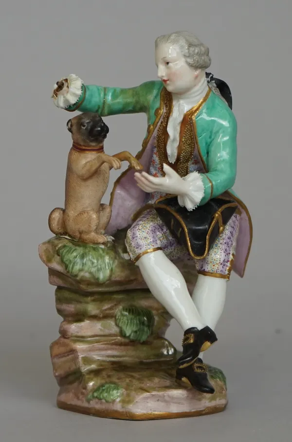 A Meissen porcelain figure, 19th century, modelled as a Victorian gentleman in a green coat playing with a pug dog, blue crossed swords mark to base,