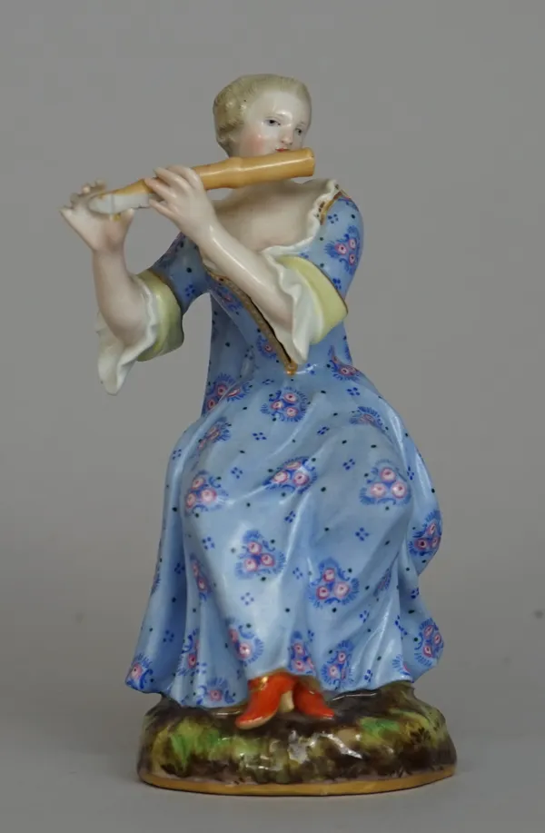 A Meissen porcelain figure, late 19th century, modelled as a Victorian lady in a foliate blue dress playing a flute, blue printed mark, incised 'No 46