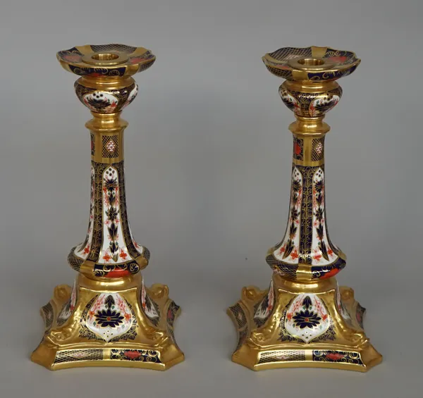 A pair of Royal Crown Derby Imari pattern bone-china candlesticks, 1980's, decorated in the `1128' pattern, red printed marks, 27cm. high, (2).