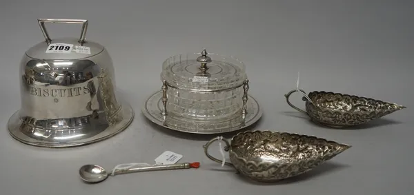A plated biscuit box, modelled as a bell, detailed Biscuits, a pair of Asian sauceboats, a spoon with a coral hand finial and a plated butter dish sta