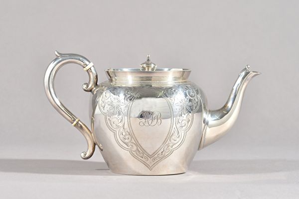 A Victorian silver teapot, with engraved decoration and oval cartouches, monogram engraved, Sheffield 1900, gross weight 454 gms.  Illustrated