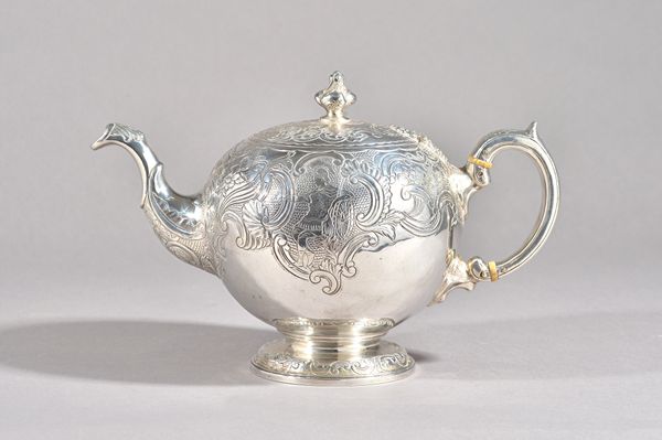 A late Victorian silver teapot, of spherical form, decorated with mythological figures, flowers and scrolls in the 18th century taste, the hinged lid