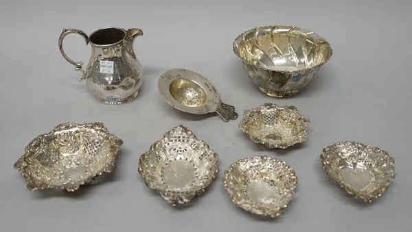 Silver, comprising; a shaped circular bowl, having spiral fluted decoration, London 1902, five various bonbon dishes, a tea strainer, Sheffield 1925 a