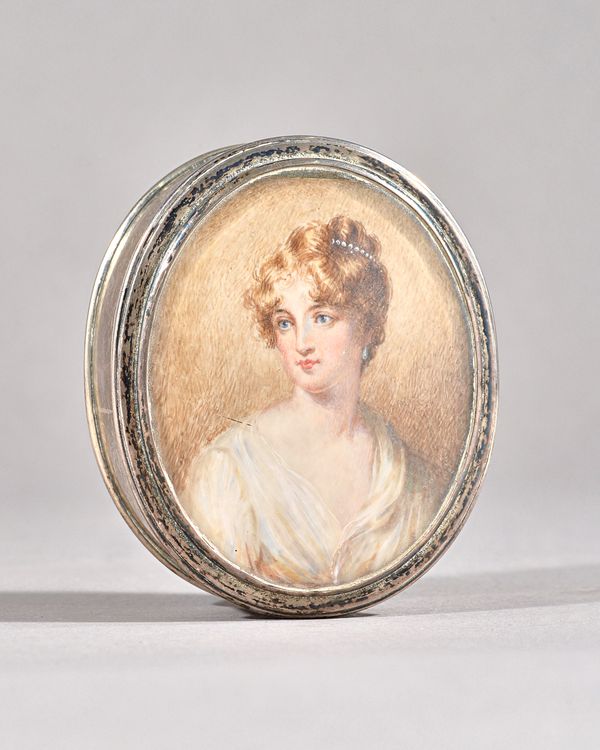 A silver oval box and cover, glazed to the cover with the portrait miniature of a lady with pale brown curly hair, wearing a white dress, by William C