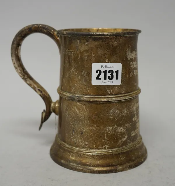 A silver mug, of tapered cylindrical form with a scrolling handle, having a heart motif terminal, in the 18th century taste, height 14cm, later presen