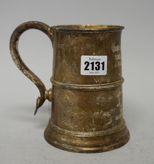A silver mug, of tapered cylindrical form with a scrolling handle, having a heart motif terminal, in the 18th century taste, height 14cm, later presen
