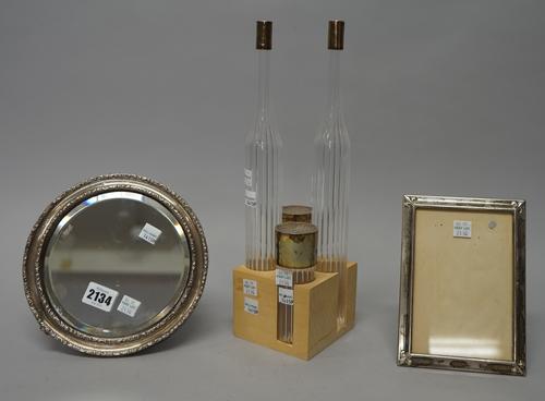 A silver mounted circular mirror, diameter 19cm, Birmingham 1912, a rectangular  foreign photograph frame and an Italian silver lidded four piece glas