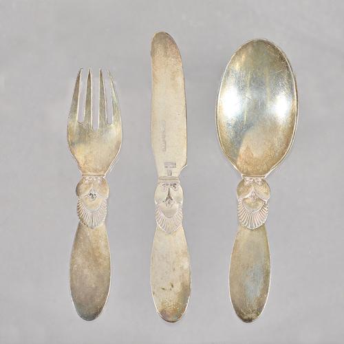 A Georg Jensen silver Cactus pattern three piece christening set, comprising; a knife, a fork and a spoon, import mark London 1935, with the retailer'