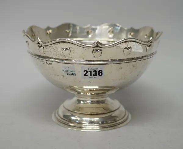 A silver centrepiece bowl, decorated with a band of hearts below a shaped rim, raised on a stepped circular foot, diameter 22cm, Sheffield 1904, weigh