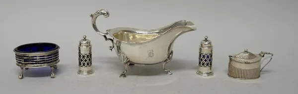 Silver, comprising; a sauceboat having a scrolling handle, raised on three pad feet, Sheffield 1925, an oval mustard pot, Birmingham 1902, a large ova