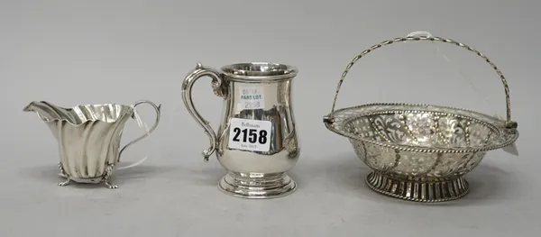 Silver, comprising; a George III small bonbon basket, of circular form, with pierced and embossed decoration and with a swingover handle, London 1764,