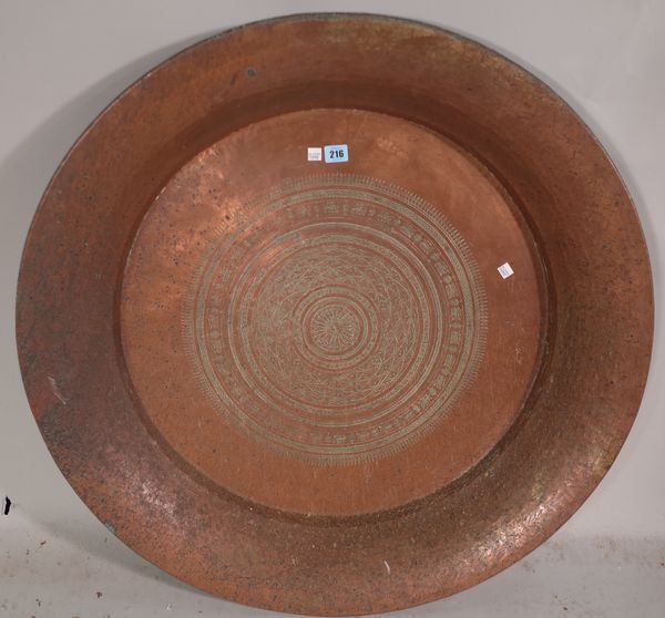 A large copper charger , late 19th century possibly Indian with foliate engraved decoration, 84cm diameter.