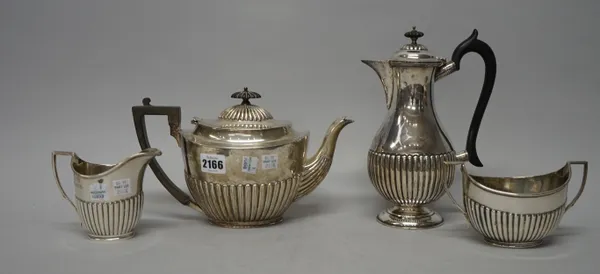 A silver composite four piece tea set, comprising; an oval teapot, with black composition fittings, London 1898, a twin handled sugar bowl and a simil