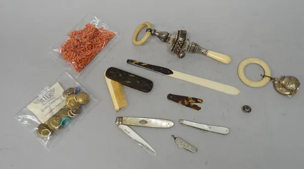 A silver bladed, mother-of-pearl folding fruit knife, Sheffield probably 1817, a babies rattle, Birmingham 1917, a plated rattle, modelled as a cat pe