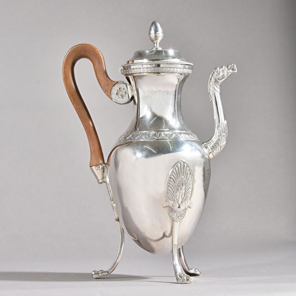 A French silver coffee pot of oval form, the body decorated with a foliate band, the spout with a horsehead terminal, the hinged lid with an acorn sha