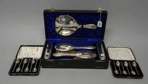 Silver and silver mounted wares, comprising; a lady's five piece dressing set, comprising; a mirror, two clothes brushes and two hair brushes (the com