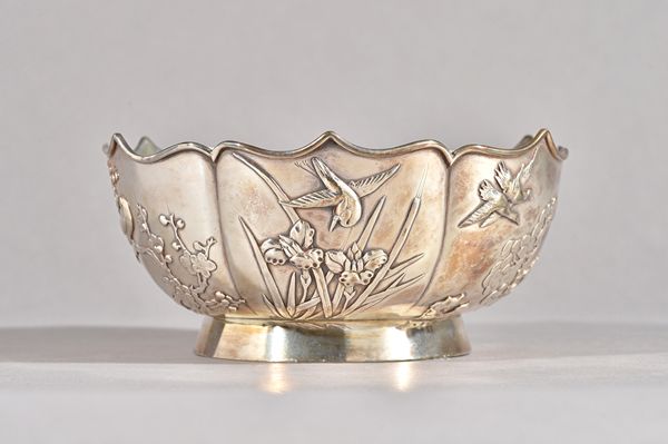 A Chinese bowl, of shaped circular form, the panelled body decorated with irises, blossom, birds and a butterfly within a shaped rim, raised on a circ