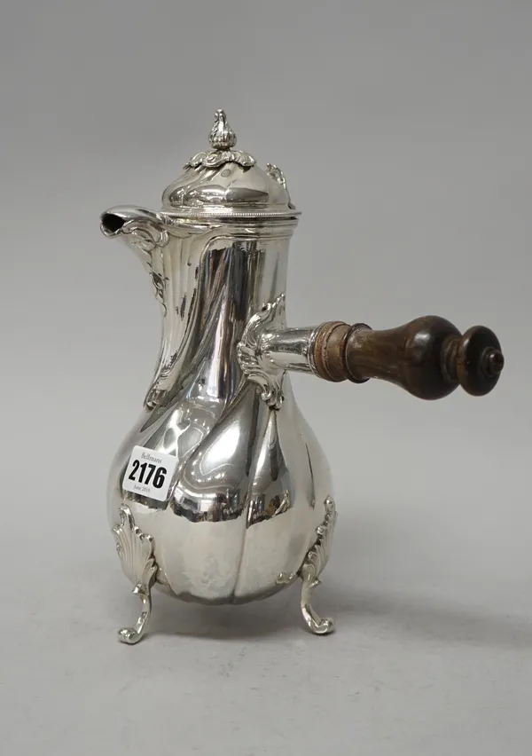 A European silver coffee pot of baluster form, the body with swirl decoration raised on three foliate capped feet, the hinged lid with a bud finial, f