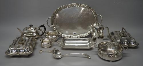 A group of plated wares, comprising; a three piece tea set with a shaped oval twin handled tray, a pair of shaped rectangular lidded entree dishes, a