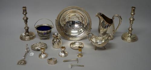 Silver, comprising; a pair of silver table candlesticks (loaded), London 1946, a pair of small candlesticks, a child's pusher and a napkin ring, forei