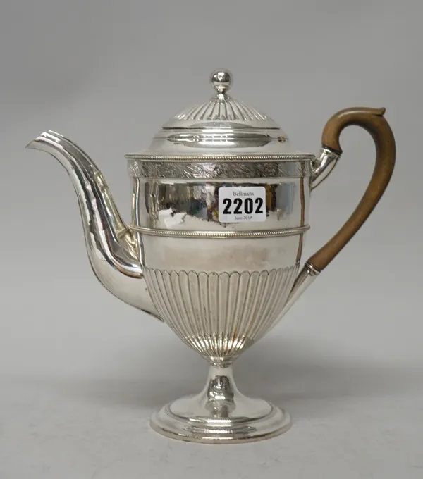 A silver plated on copper coffee pot, of Adam shaped urn form with partly fluted decoration below a foliate decorated band, raised on a circular foot,