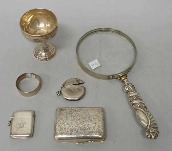 Silver and silver mounted wares, comprising; an Edwardian circular vesta case, Chester 1909, a rectangular vesta case, a cigarette case with engraved