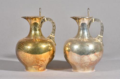 Two Victorian silver water jugs, William And George Sissons, London, 1875 and 1876, one gilt and with engraved crest, the other plain, each with ivory