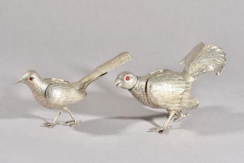 Two late 19th/early 20th century Continental silver novelty pepperettes, marks indistinct, each modelled as a bird with red glass eyes, removable head