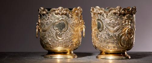 A pair of late Victorian silver gilt cache-pots, Charles Stuart Harris, London, 1900, each of George II style with glass liners (one liner possibly as