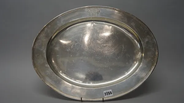 A George V silver meat dish of oval form, Charles and Richard Comyns, London, 1924 with engraved coat-of-arms, 49.5cms wide, 38.4cms high, 1,410g.