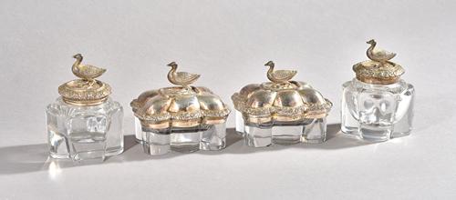 A pair of George IV silver and moulded glass box and covers, probably Joseph Angell, London 1829, each surmounted by a duck final and floral banded li