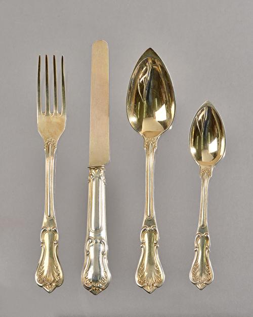 A late 19th century French silver gilt dinner service in a Rococo pattern by Claude Doutre Roussel, comprising: twelve table spoons, twelve table fork