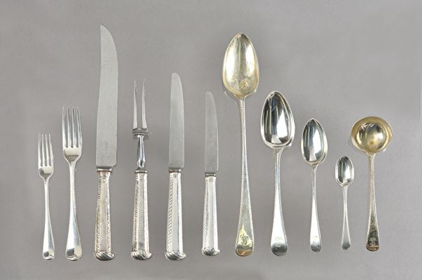 A matched silver flatware service in the feather edge pattern, assorted dates and makers but predominately early 19th century, part bearing heraldic c