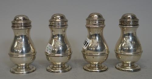 A set of four silver baluster shaped casters in the early 18th century manner, Searle & Co. London 1951, each with elephant head crest, 12.cms high, a