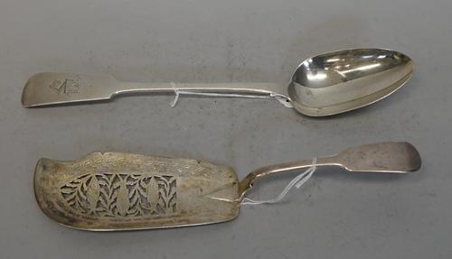 A Victorian Irish silver basting spoon, John Smyth Dublin 1853, engraved WPA and with armorial of armoured arm holding a head aloft, 32cms long, 142g.