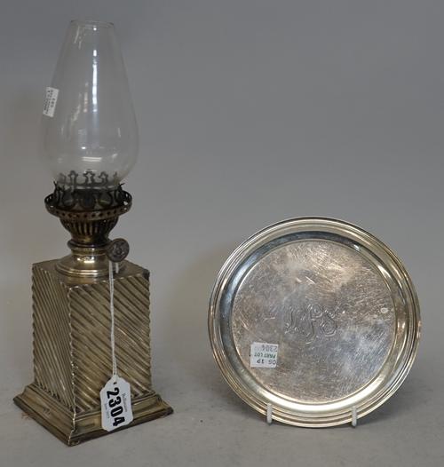 A late Victorian silver cased oil lamp base, maker's mark rubbed, Birmingham 1890, 8.5cms wide, 28cms high including glass shade; a small American ste