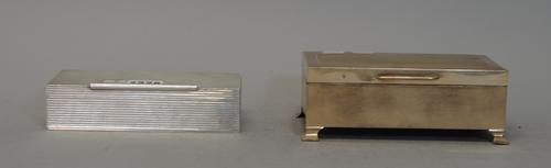 A silver cigarette box, of rectangular form, with all over reeded decoration and tubular thumbpiece, Birmingham 1961, weight 548 gms and another large