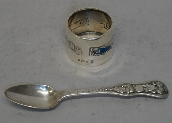 Liberty & Co Ltd, a silver and enamel napkin ring, of circular form with enamel Celtic motifs, Birmingham 1902 and a Continental spoon, the handle wit