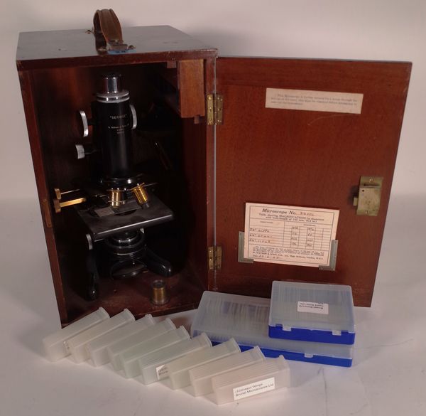 A 20th century Watson service microscope, cased and slides.