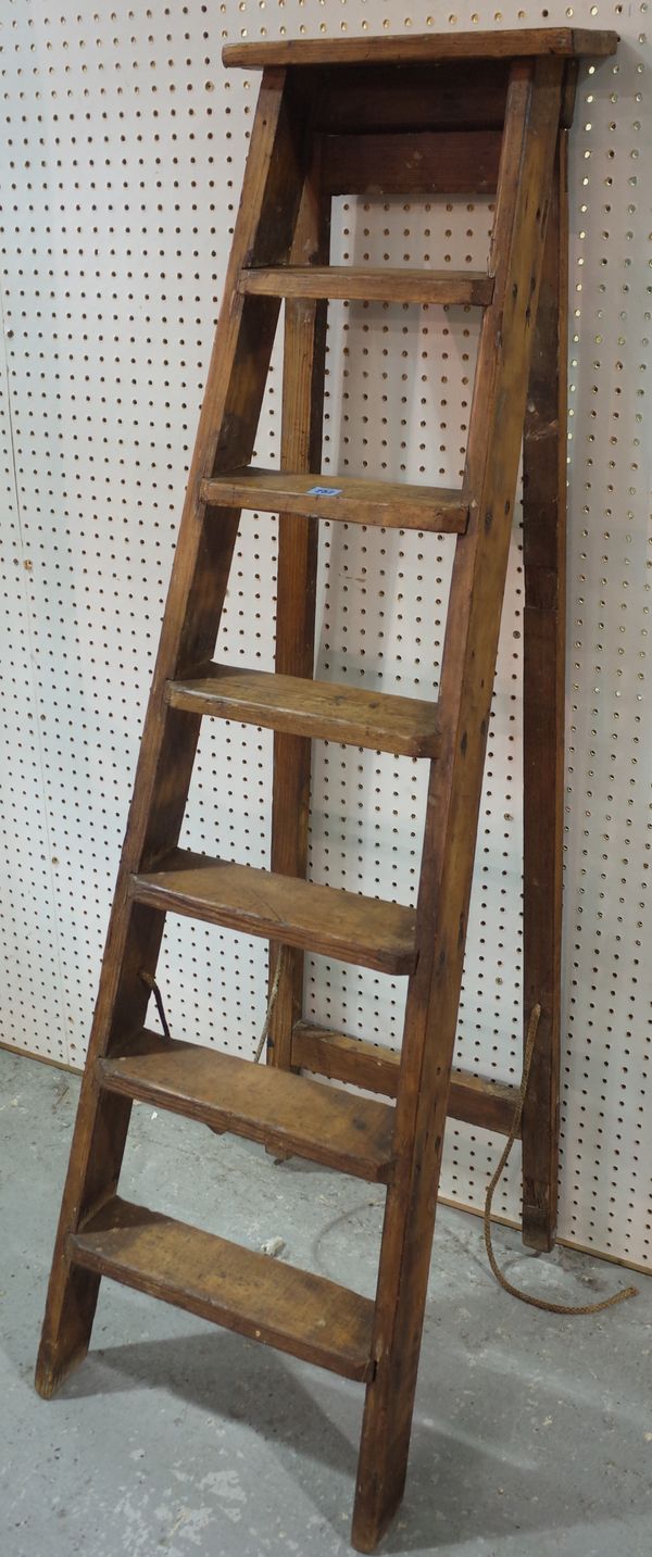 An early 20th century pine A frame ladder with six steps, 152cm tall.