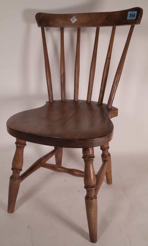 An early 20th century beech framed child's stick back chair, 61cm tall.