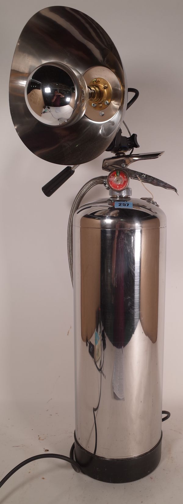 A 20th century chrome plated fire extinguisher converted to a lamp, 120cm high.