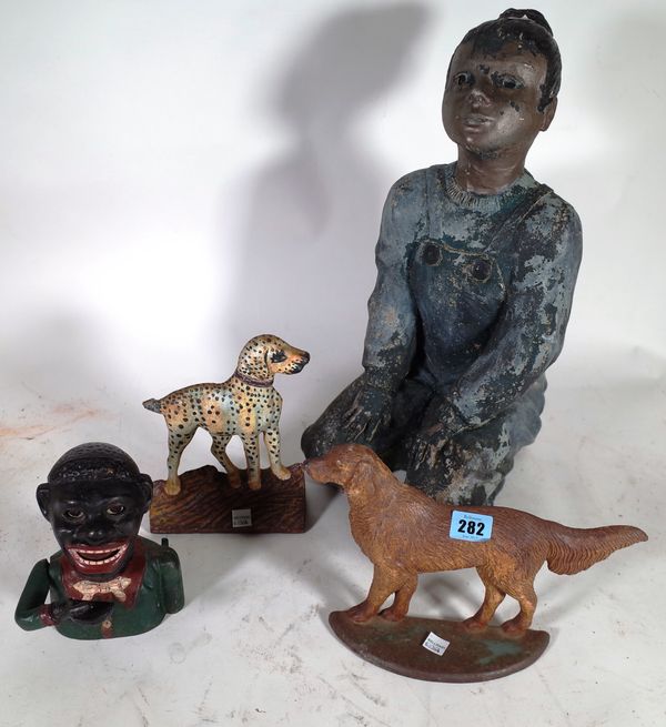 A cast iron "Jolly" money box and two cast iron door stops formed as dogs, (qty).