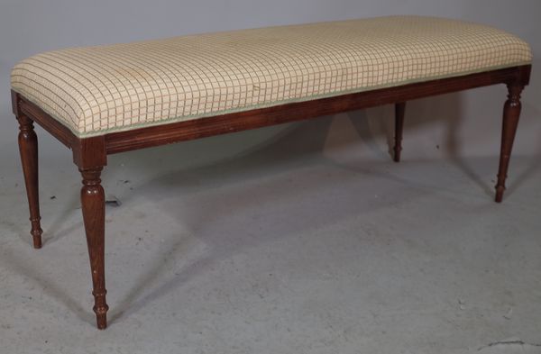 A rectangular footstool on mahogany baluster supports, 118cm wide x 48cm high.