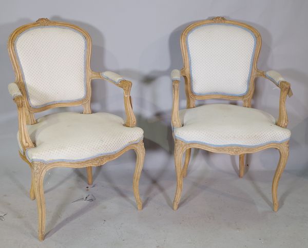 A pair of Louis XV style beech framed open armchairs, with serpentine seat on cabriole supports, 61cm wide x 97cm high.   1