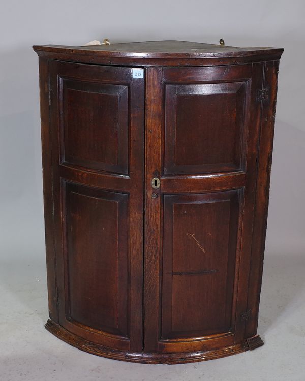 An 18th century oak hanging corner cupboard, with pair of double panelled doors, 80cm wide x 103cm high,   21